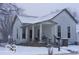 Quaint two-story home featuring a porch and classic architecture, covered in snow at 1516 Sycamore St, Columbus, IN 47201
