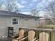 Backyard deck with wooden chairs and stone siding on the home at 2104 W Barcelona Dr, Muncie, IN 47304