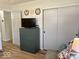 Bedroom featuring a gray dresser, sliding closet door, and cozy seating area at 2104 W Barcelona Dr, Muncie, IN 47304