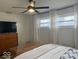 Bedroom with a ceiling fan, large windows, and television at 2104 W Barcelona Dr, Muncie, IN 47304