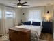 Bedroom with a ceiling fan, large windows, and two dressers at 2104 W Barcelona Dr, Muncie, IN 47304