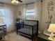 Cozy Bedroom with crib, animal decor, hardwood floor and neutral color palette at 2104 W Barcelona Dr, Muncie, IN 47304