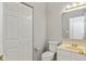 Cozy bathroom featuring a toilet, sink, mirror, and closed closet at 2218 Colfax Ln, Indianapolis, IN 46260
