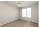 Clean bedroom with neutral carpet, a ceiling fan, and a bright window at 2218 Colfax Ln, Indianapolis, IN 46260