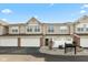 Charming townhouse featuring a two-car garage and welcoming curb appeal with neutral siding and a well-maintained landscape at 2218 Colfax Ln, Indianapolis, IN 46260