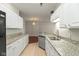Well-lit kitchen with white cabinets, granite countertops, and stainless steel appliances at 2218 Colfax Ln, Indianapolis, IN 46260