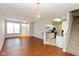 Open-concept space with hardwood floors that lead to the kitchen featuring granite countertops and the staircase at 2218 Colfax Ln, Indianapolis, IN 46260