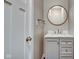 Charming bathroom with round mirror, marble countertop vanity, and modern fixtures at 2308 Nowland Ave, Indianapolis, IN 46201