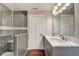 Bathroom features tiled shower, wood floors, double sink vanity, and lots of lighting at 2308 Nowland Ave, Indianapolis, IN 46201