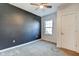 Bedroom features a dark accent wall, plush carpet, and plenty of natural light at 2308 Nowland Ave, Indianapolis, IN 46201