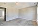 Neutral bedroom with light-colored walls and carpeted floors shows open door to hallway at 2308 Nowland Ave, Indianapolis, IN 46201