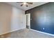 Bedroom with a dark accent wall, plush carpet, and a door leading to a hallway at 2308 Nowland Ave, Indianapolis, IN 46201