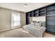 Bedroom with hidden bed and shelving, plush carpet, and natural light from window at 2308 Nowland Ave, Indianapolis, IN 46201