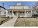 Charming two-story home featuring a large, inviting front porch with classic architectural details at 2308 Nowland Ave, Indianapolis, IN 46201