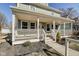 Charming two-story home with a large front porch and well-manicured landscaping at 2308 Nowland Ave, Indianapolis, IN 46201