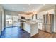 Modern kitchen featuring white cabinetry, a central island, stainless steel appliances, and access to the patio at 2308 Nowland Ave, Indianapolis, IN 46201