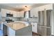Well-equipped kitchen with an island, stainless steel appliances, and white cabinetry at 2308 Nowland Ave, Indianapolis, IN 46201