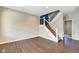 Bright living room featuring sleek hardwood floors, a staircase, and a modern color palette at 2308 Nowland Ave, Indianapolis, IN 46201