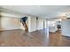 Bright, open-concept living space featuring sleek hardwood floors, a staircase, and a modern kitchen at 2308 Nowland Ave, Indianapolis, IN 46201