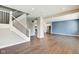 Bright, open-concept living space featuring sleek hardwood floors, a staircase, and a modern kitchen at 2308 Nowland Ave, Indianapolis, IN 46201