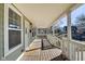 Open porch, with wood floors, is perfect for relaxing and enjoying the outdoors at 2308 Nowland Ave, Indianapolis, IN 46201