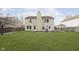 Expansive backyard with a well-maintained lawn, patio, and fencing offers ample space for various outdoor activities at 3113 Cassara Dr, Indianapolis, IN 46203