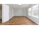 An empty bedroom featuring wood-look flooring and natural light from the windows at 3113 Cassara Dr, Indianapolis, IN 46203