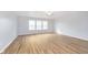 An empty bedroom featuring three windows and wood-look flooring at 3113 Cassara Dr, Indianapolis, IN 46203