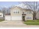 Charming two-story home with a three car garage and well-manicured lawn at 3113 Cassara Dr, Indianapolis, IN 46203