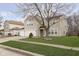 Well-maintained two-story home features green grass, a mature tree and a three-car garage at 3113 Cassara Dr, Indianapolis, IN 46203