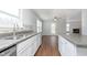 Bright kitchen is equipped with granite countertops, white cabinets, stainless steel appliances, and backyard views at 3113 Cassara Dr, Indianapolis, IN 46203