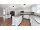Bright kitchen showcases white cabinets, stainless appliances, granite counters, and center island at 3113 Cassara Dr, Indianapolis, IN 46203
