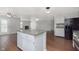 Open kitchen with island features stainless steel appliances, granite countertops, and white cabinets at 3113 Cassara Dr, Indianapolis, IN 46203