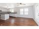 Well-lit eat-in kitchen featuring hardwood floors, white cabinets, stainless appliances, and granite countertops at 3113 Cassara Dr, Indianapolis, IN 46203