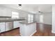 Stylish kitchen features white cabinets, stainless appliances, granite counters, and an island at 3113 Cassara Dr, Indianapolis, IN 46203