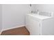 A white laundry room featuring a washer and dryer with wood-look flooring at 3113 Cassara Dr, Indianapolis, IN 46203