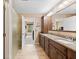 This bathroom boasts a double vanity with stone countertop and tiled flooring at 34 Gettysburg, Coatesville, IN 46121