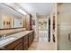 Bathroom boasts a double vanity with stone countertop, and a glass enclosed shower at 34 Gettysburg, Coatesville, IN 46121