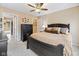Spacious bedroom features a ceiling fan, a dark wood dresser and walk in closet at 34 Gettysburg, Coatesville, IN 46121