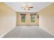 Bright bedroom with neutral walls, ceiling fan, carpet flooring, and windows with exterior views at 34 Gettysburg, Coatesville, IN 46121
