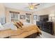 Cozy bedroom featuring large windows, ceiling fan, and neutral color scheme at 34 Gettysburg, Coatesville, IN 46121