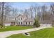 Traditional two-story home with a well-manicured lawn, attached garage, and detached garage in a treed area at 34 Gettysburg, Coatesville, IN 46121