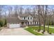 Two-story home with attached garage, manicured lawn and landscaping at 34 Gettysburg, Coatesville, IN 46121