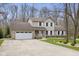 Traditional home featuring an attached garage with a basketball hoop, manicured lawn, and classic architectural details at 34 Gettysburg, Coatesville, IN 46121