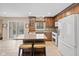 Updated kitchen with stainless appliances, granite counters, island seating, and tile backsplash at 34 Gettysburg, Coatesville, IN 46121