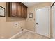 Functional laundry room with overhead cabinets and tile flooring at 34 Gettysburg, Coatesville, IN 46121