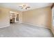 Cozy living room with neutral carpet and paint, seamlessly connecting to the adjacent dining area at 34 Gettysburg, Coatesville, IN 46121
