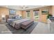 Stylishly staged main bedroom with plush bedding, modern decor, and large windows for ample natural light at 34 Gettysburg, Coatesville, IN 46121