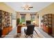 Well-lit home office featuring built-in shelving and large windows with views of the landscaped lawn at 34 Gettysburg, Coatesville, IN 46121
