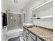 Bright bathroom featuring granite counters, tiled shower, and modern lighted mirror at 3708 Magenta Ln # 3, Indianapolis, IN 46214
